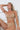 Woman relaxing in chair wearing Purty Body seamless nude Active Nipple Bra and thong with a confident, comfortable fit