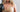 Athletic woman wearing Purty Body nude seamless shapewear bra and thong with boxing gloves in front of punching bag